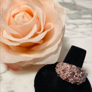 Silver tone ring with pink stones.